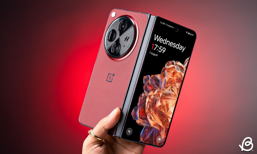 shot of a hand holding the OnePlus Open semi unfolded in front of a red background shot of a hand holding the OnePlus Open semi unfolded in front of a red background