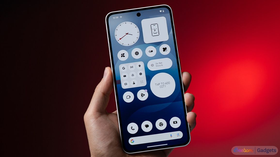 shot of a hand holding the Nothing Phone (3a) showing the home screen setup shot of a hand holding the Nothing Phone (3a) showing the home screen setup