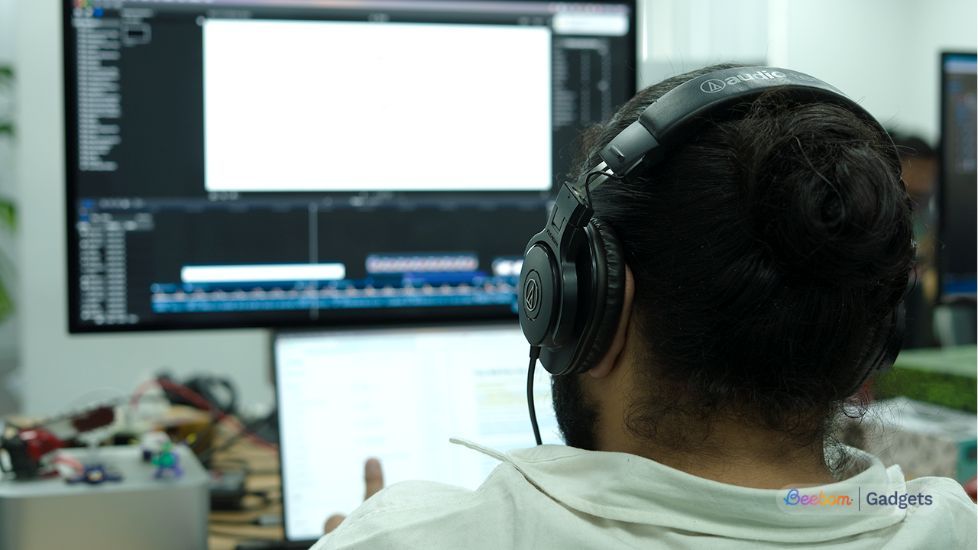 Person sitting on a chair with Audio Technical ATH-MX50s on head Person sitting on a chair with Audio Technical ATH-MX50s on head