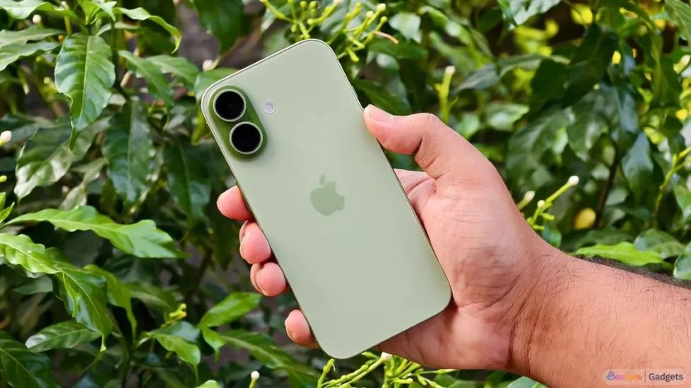 Person holding a green iPhone 17 in hand from the back Person holding a green iPhone 17 in hand from the back