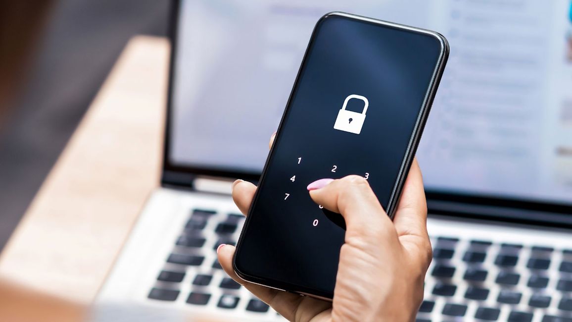 App Lock feature shown on an Android smartphone with an open Laptop backdrop