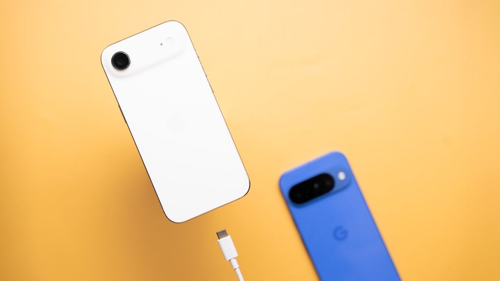 Apple iPhone with a USB-C cable and Pixel 10 in the background