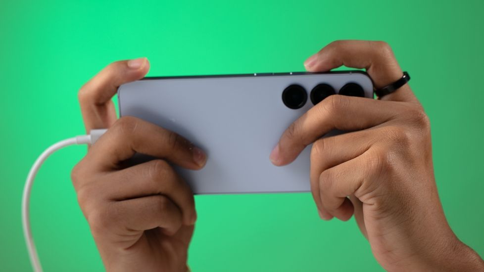 Person holding a phone horizontally while plugged in