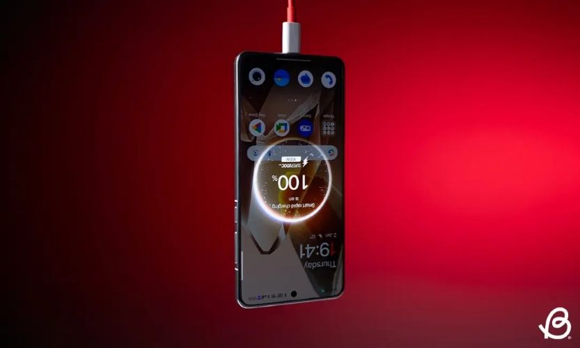 OnePlus 13 hanging upside down connected to a charging cable