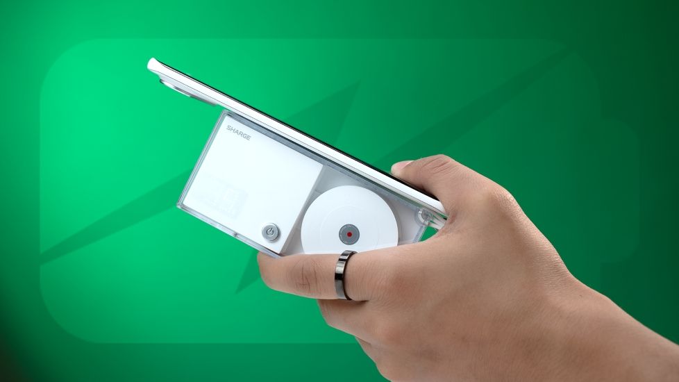 Person holding an Android smartphone plugged into a powerbank