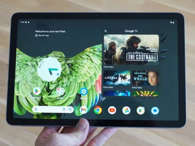 Google Pixel Tablet in hand on the home screen