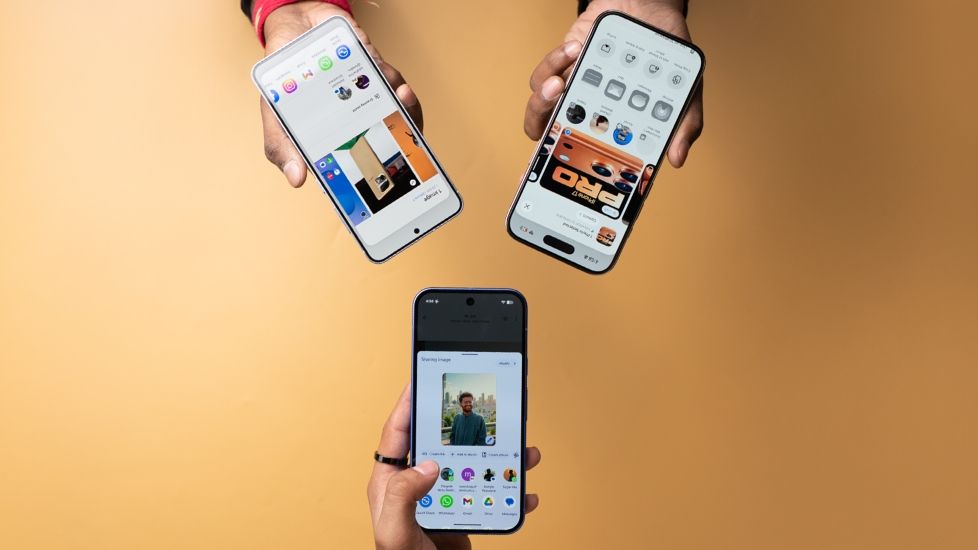 People holding three phones in hand