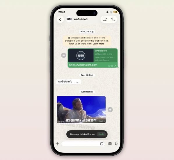 WhatsApp chat on an iPhone with a GIF from Klipy