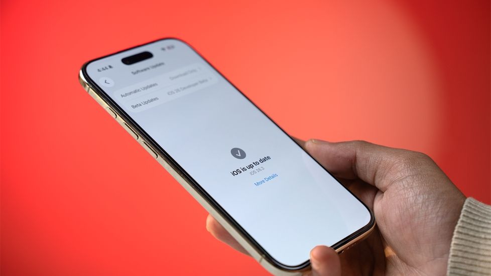 Person holding an iPhone Air on the software updates page