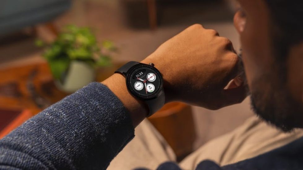 Person wearing a motorola watch on the wrist