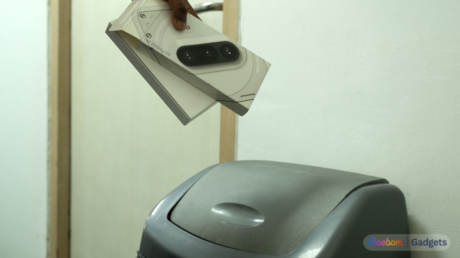 Nothing Phone boxes being thrown into a trash bin