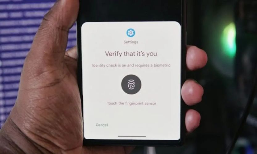 Person holding a phone with an identity check popup