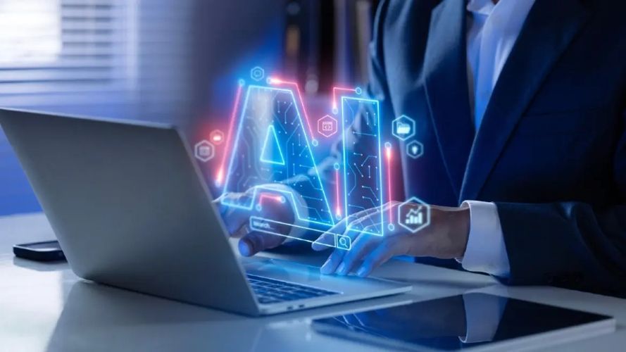 shot of a person interacting with a laptop with the AI text hovering above