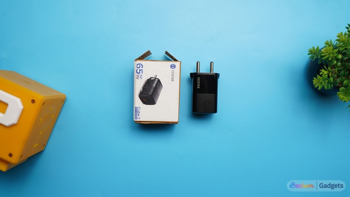 CoStar 65W charger top down shot on a blue background