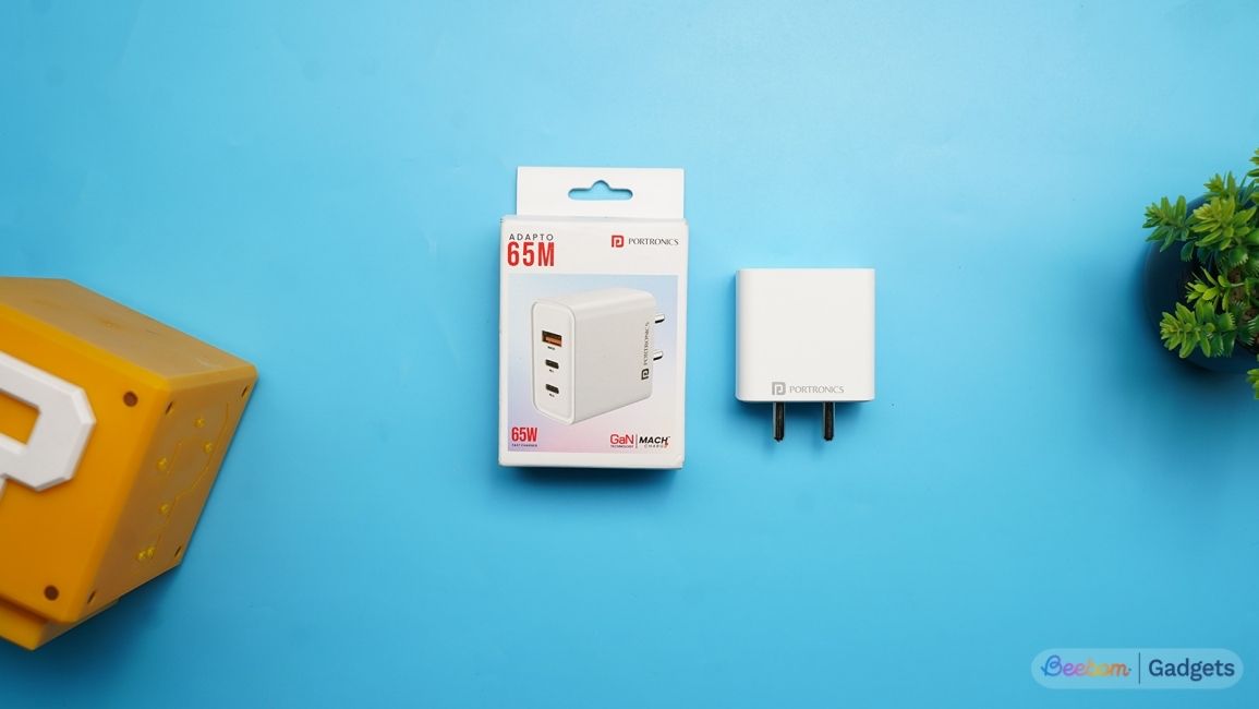 Portronics 3 port 65W GaN Charger white against a blue background