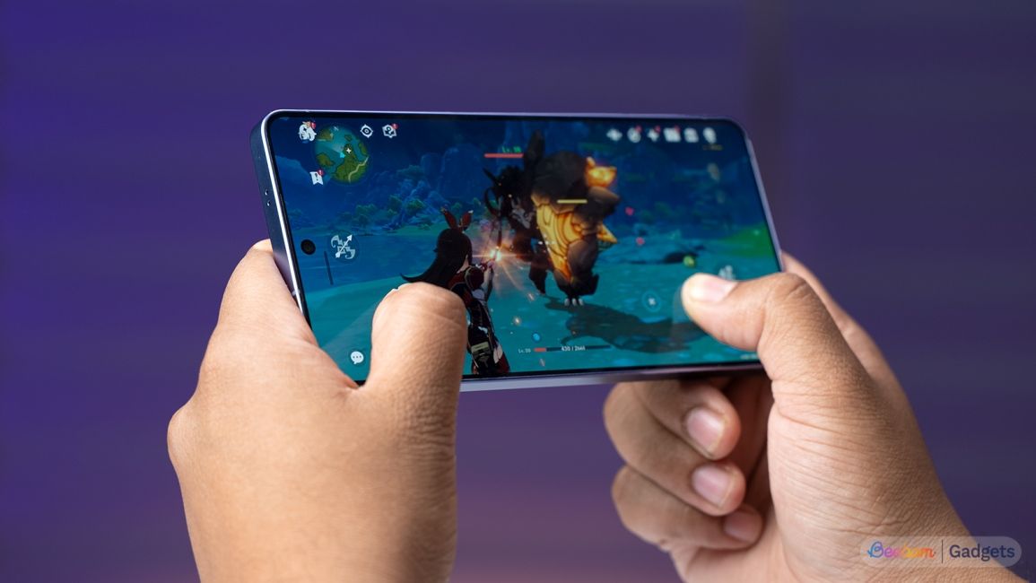 Samsung Galaxy S26 Ultra playing Genshin Impact on the screen against a purple background