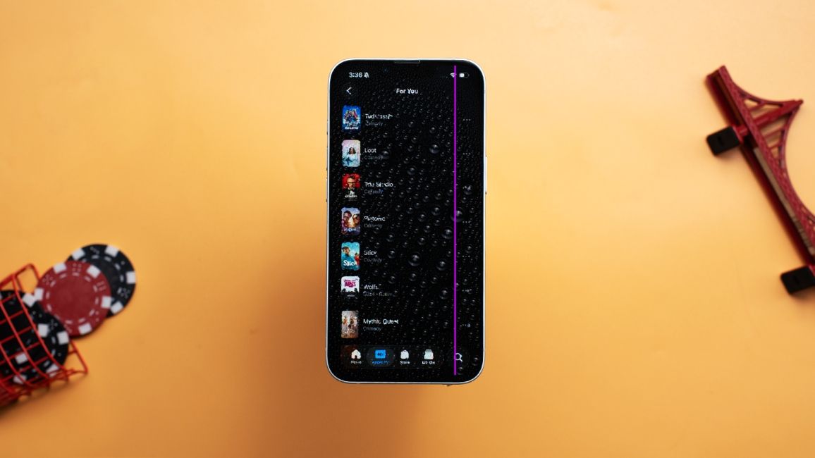 iPhone display with water damage showing a purple line