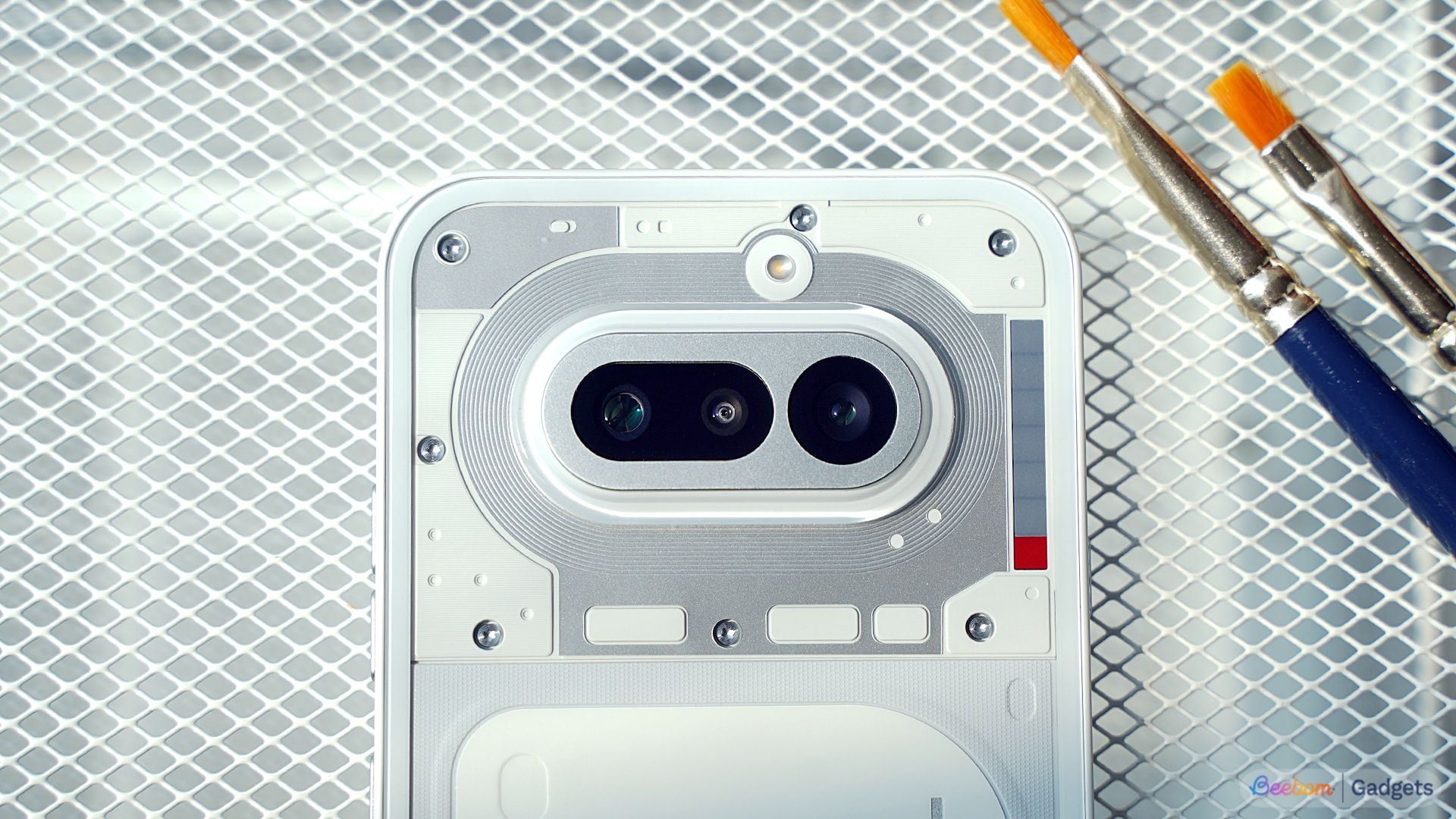 close up shot of the Nothing Phone (4a) camera module with phone placed on a mess grille surface