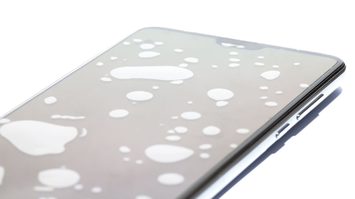 shot of a phone showing white air bubbles or dots on screen shot of a phone showing white air bubbles or dots on screen