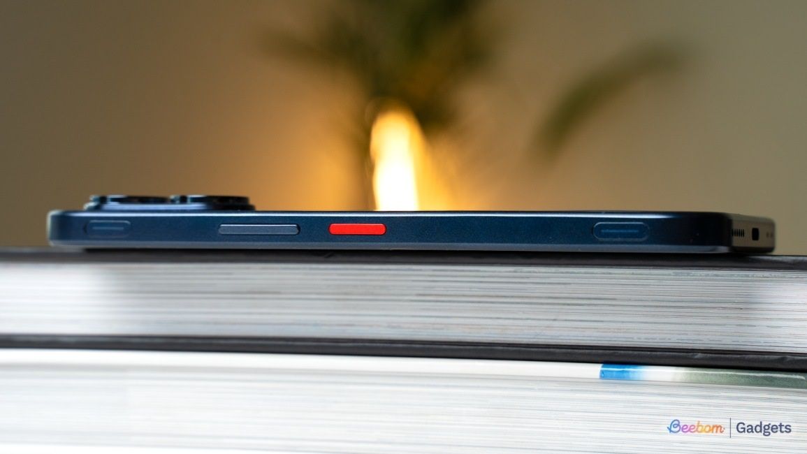 Ai Plus Nova 2 Ultra buttons shown from the side while the phone is laying on top of a book