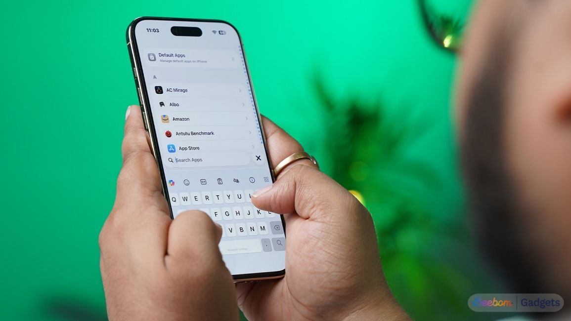 Someone-holding-an-iPhone-Air-typing-on-it-against-a-green-background
