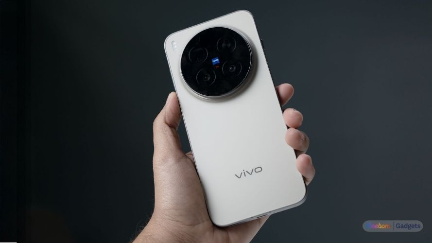 vivo X300 Pro smartphone held from the back in gold colourway