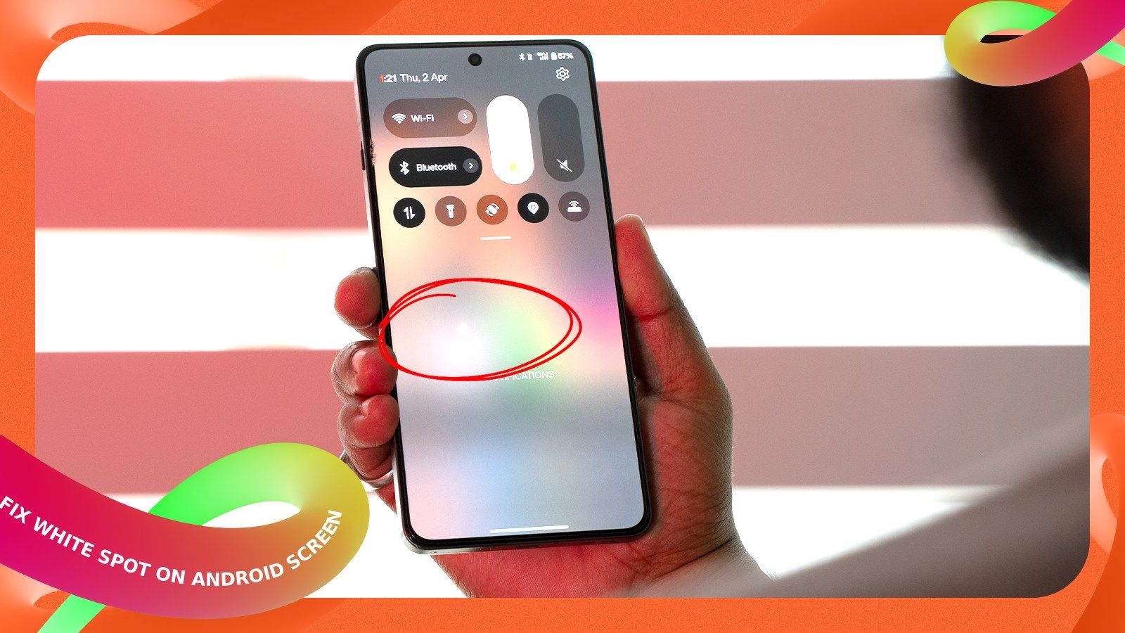a user holding an android phone with a white spot on the screen a user holding an android phone with a white spot on the screen