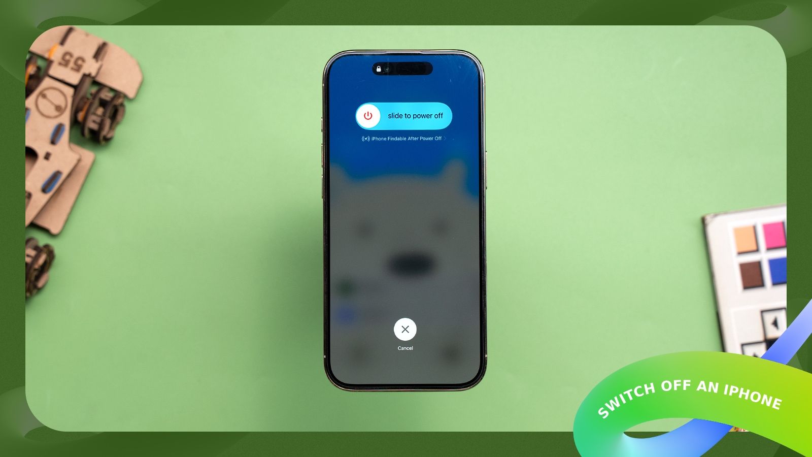shot of an iPhone placed on a desk showing the Slide to Power Off option in iOS