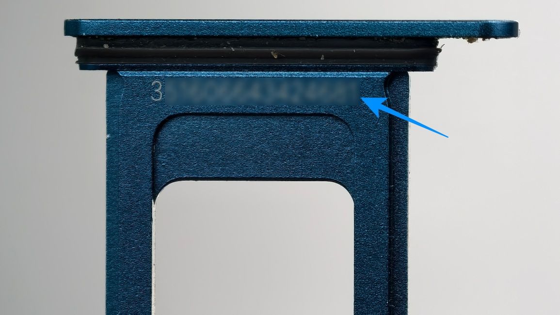 iPhone 13 SIM tray showing the IMEI number