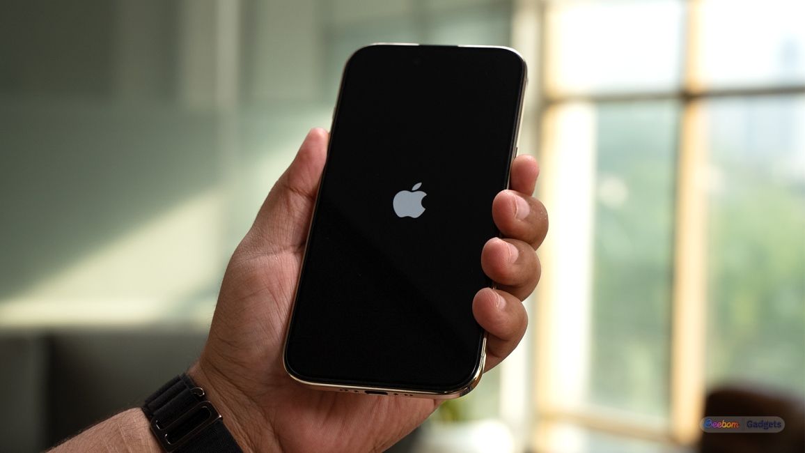 iPhone in hands showing the Apple logo on the screen iPhone in hands showing the Apple logo on the screen