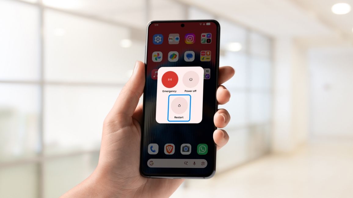 shot of a hand holding an Android phone showing Restart option 