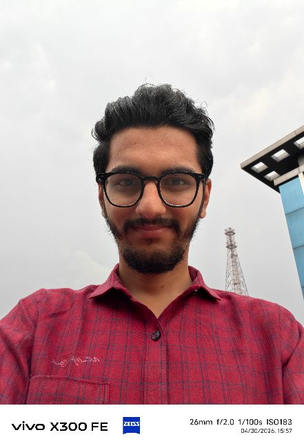 A person wearing glasses and a red checkered shirt