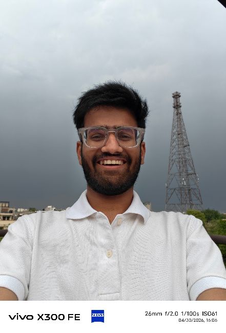 A person wearing clear glasses with a half shirt
