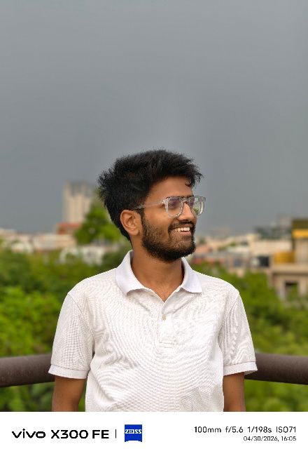 A person wearing a white shirt posing for a portrait
