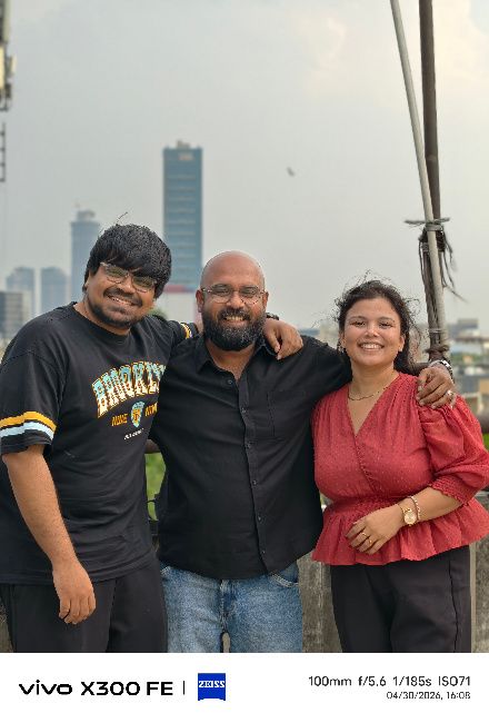 Three people posing for a group photo