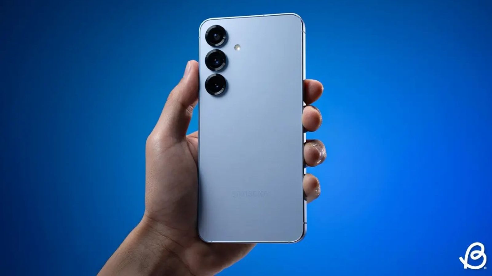 Galaxy S25 smartphone in blue colourway held in hand from the back