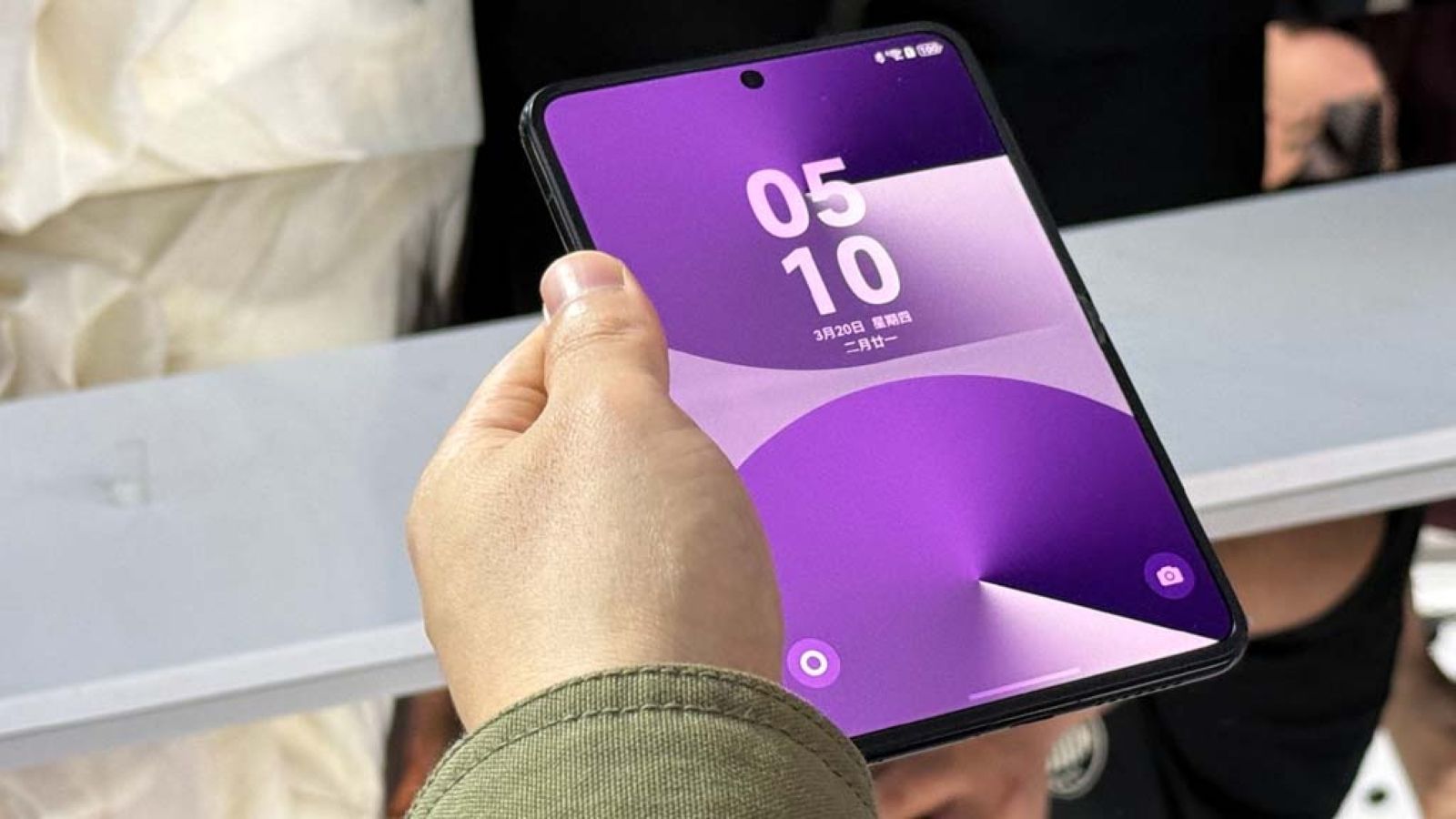 Huawei Pura X held in hand unfolded and vertically