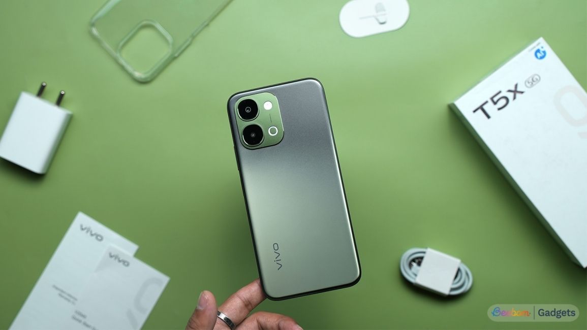 Vivo T5x box contents spread around on a green background