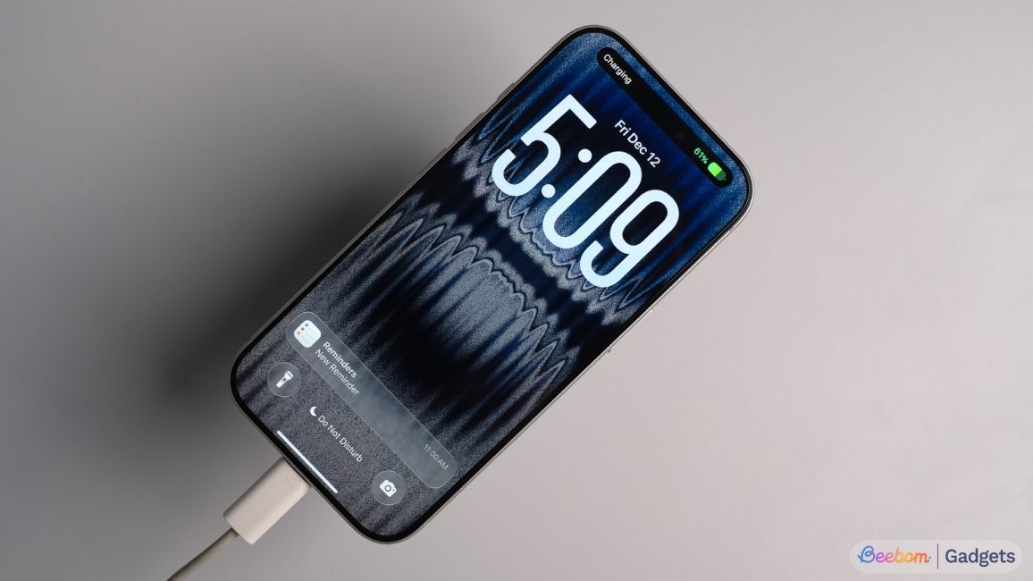 shot of iPhone 17 Pro placed face up on a table showing charging notification