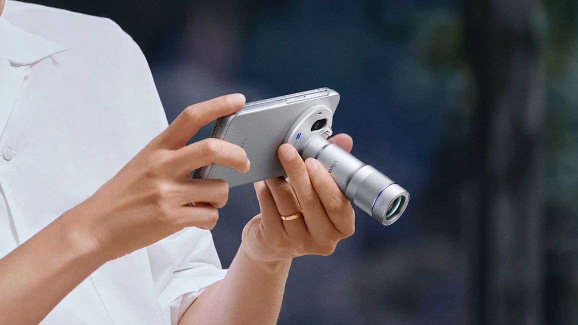 Vivo X Fold 6 held in hand with the Teleconverter camera unit attached