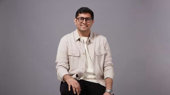 Himanshu Tandon sitting wearing a beige jacket