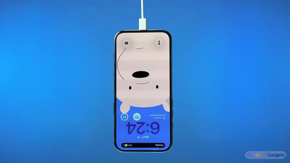 Image of iPhone Air Plugged in the charger while hanging upside down against a blue background
