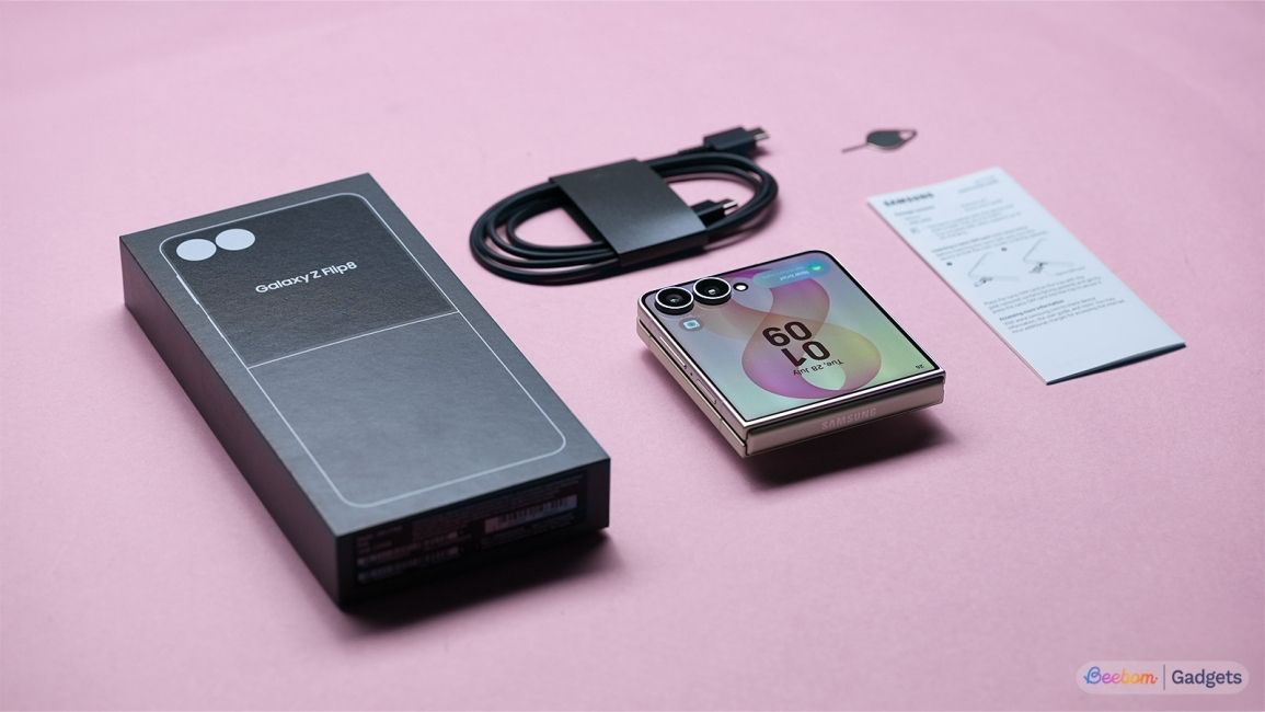 Samsung Galaxy Z Flip 8 Box contents laid out on a pink background Samsung Galaxy Z Flip 8 Box contents laid out on a pink background