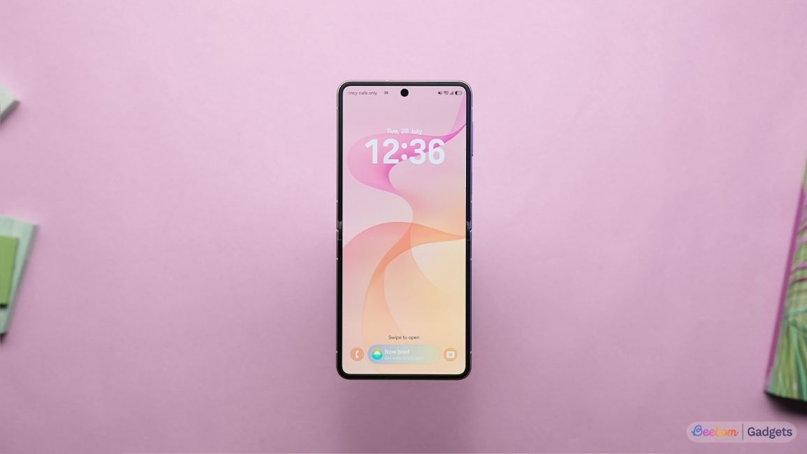 Samsung Galaxy Z Flip 8 display unfolded laid on a pink background Samsung Galaxy Z Flip 8 display unfolded laid on a pink background
