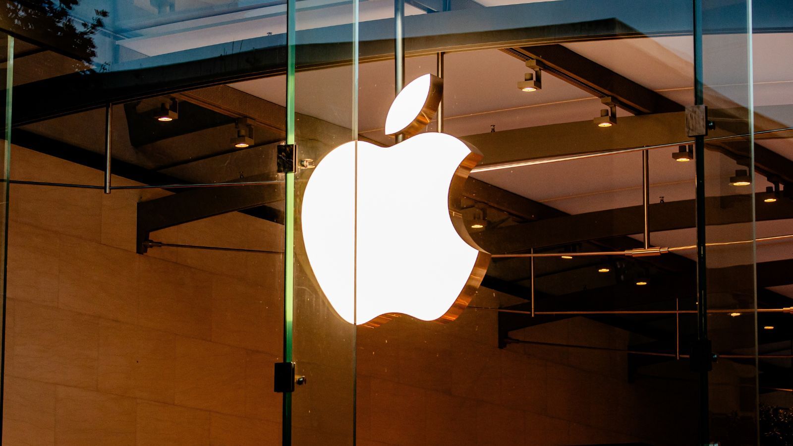 Apple logo on a glass building reflecting the sunlight Apple logo on a glass building reflecting the sunlight
