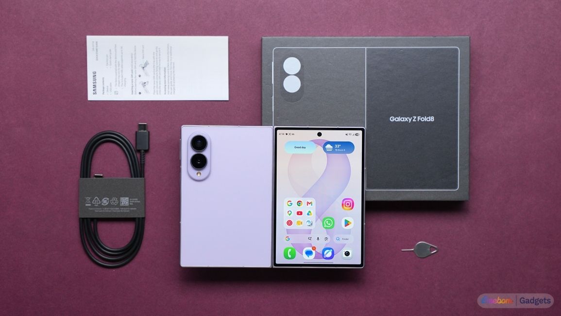 Galaxy Z Fold 8 box contents laid out on a maroon table 