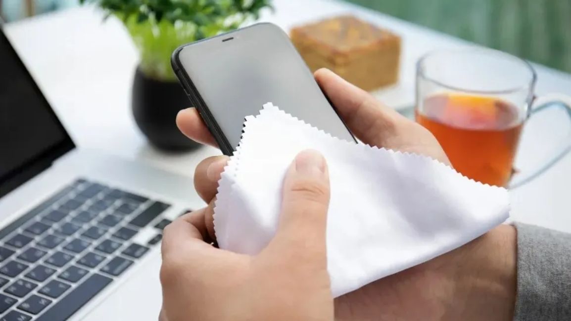Image showing someone cleaning their phone screen with a soft cloth