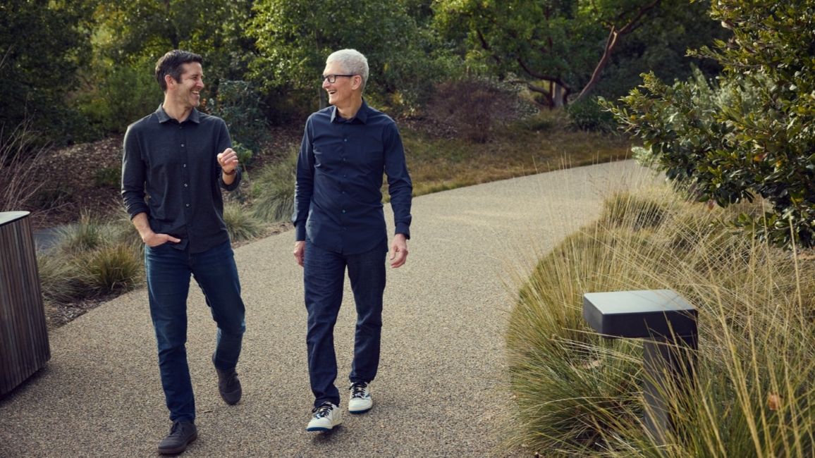 Apple's John Ternus and Tim Cook walking side by side at Apple Park