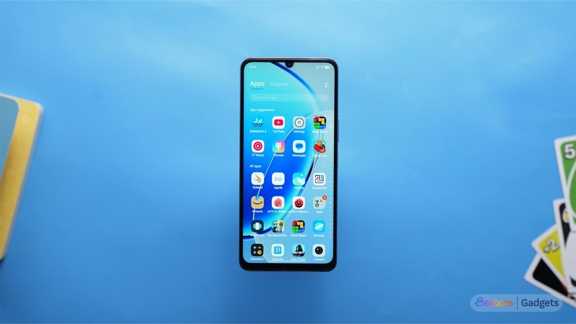 Vivo T5 Lite 5G homescreen shown with the phone laying flat on a blue background Vivo T5 Lite 5G homescreen shown with the phone laying flat on a blue background