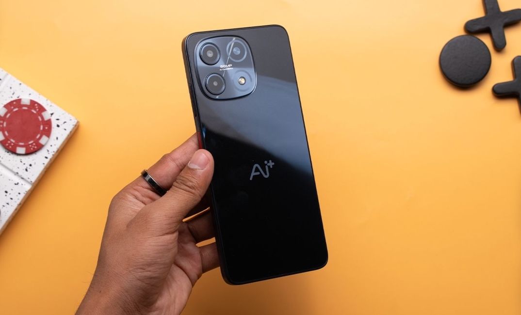 Ai+ Nova 2 in held in hand in black colourway from the back